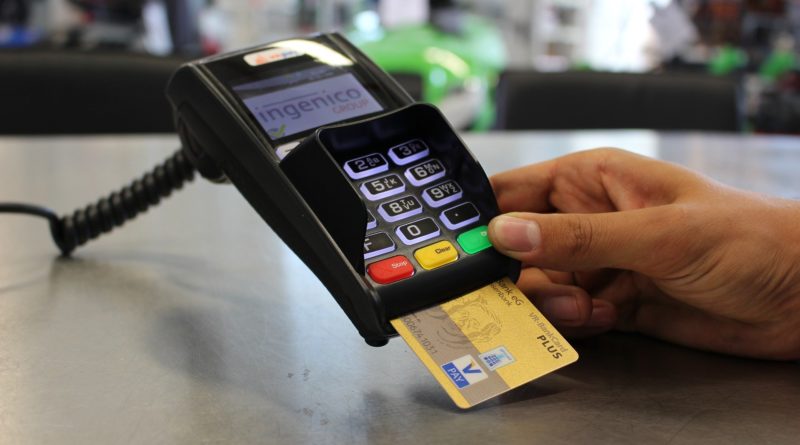 person paying by card - millennials living on a budget