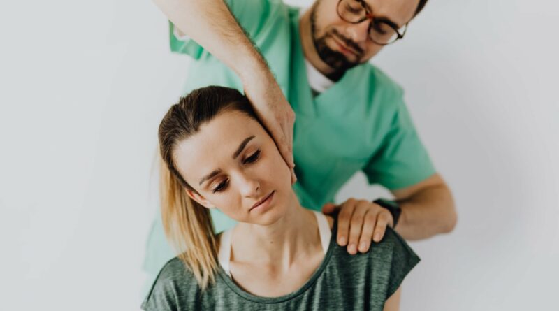 Man performing chiropractic care on woman