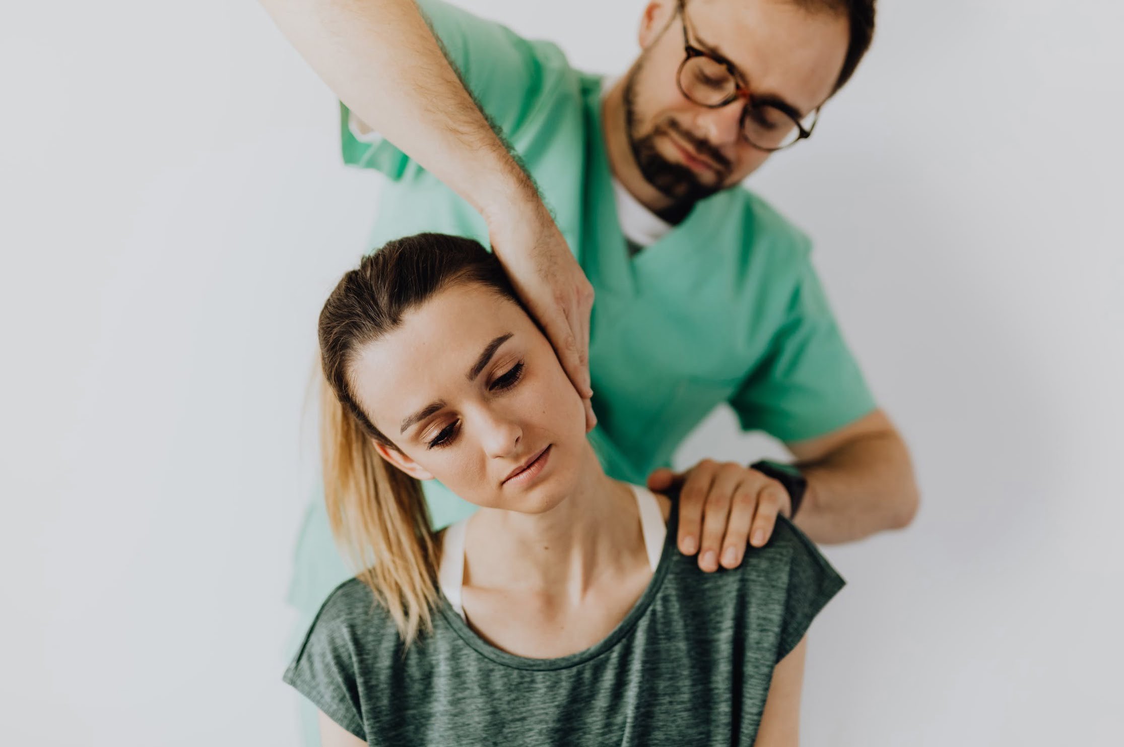 Man performing chiropractic care on woman